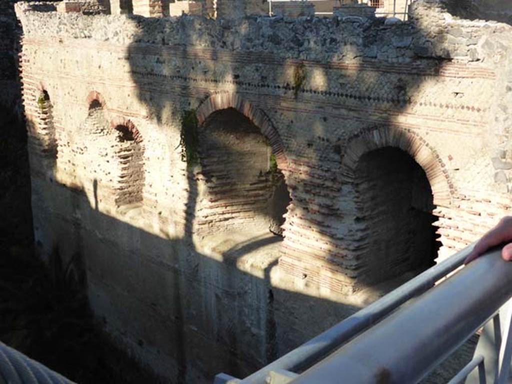 II.1 Herculaneum, September 2015.
Windows overlooking beachfront from lower floors of Casa di Aristide. Looking north-west from access bridge.
According to Maiuri, little remains that is intelligible of the original plan of the building as so many underground passages were cut across it by the Bourbons, and because of the restorations made at the time.
The atrium, and the rear of the house were constructed on the brow of the hill, all the rest which projected outwards over the lowest and steepest slope of the promontory was supported upon robust vaulted constructions that form a powerful supporting bastion with concrete walls, sometimes three metres thick, faced externally with brick and internally with opus reticulatum.
See Maiuri, Amedeo, (1977). Herculaneum. 7th English ed, of Guidebooks to the Museums Galleries and Monuments of Italy, No.53 (p.23).
